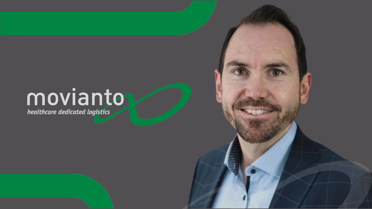 Dennis Spamer portrait shoulders up smiles at the camera with the Movianto logo next to him